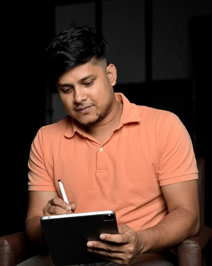 Raisul writing on a tablet with a stylus, working.